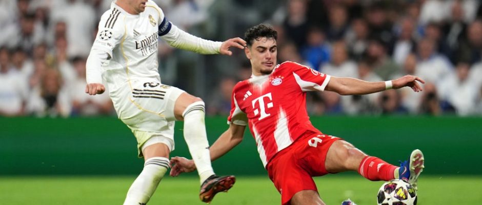 MADRID, SPAIN - APRIL 07: Aleksandar Pavlovic of FC Bayern Munich is challenged by Federico Valverde of Real Madrid during the UEFA Champions League 2025/26 Quarter-Final First Leg match between Real Madrid CF and FC Bayern München at Estadio Santiago Bernabeu on April 07, 2026 in Madrid, Spain. (Photo by Aitor Alcalde/Getty Images)